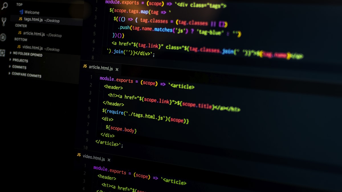 Hands typing code on a laptop